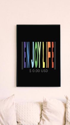 a black framed art print with the words enjoy life $ 0 00 usd in multicolored letters