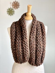 a brown knitted scarf on top of a mannequin