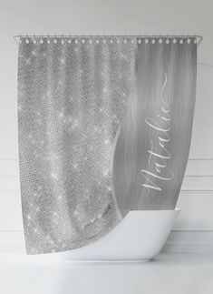 a silver shower curtain with the word happy on it and sparkles in the background