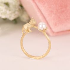 Japan Akoya Pearl 3D Cat Ring, Cat Wedding Ring, Cute Cat Promise Ring, Cat Themed Engagement Ring, Unique Gifts For Cat Lovers, Kitten Ring ✧･ﾟ: *✧･ﾟ:* Welcome to Charles Davin Jewelry*:･ﾟ･ﾟ✧ Moissanite - a gemstone known to bring in luck in someone's life, the user can give off a look of elegance. You can give your special someone luck whilst showing your love to them. ✶Material: 10K/ 14K/ 18K ✶Main Stone: Japanese Akoya Pearl; approx. 5.5mm ✶Side Stone: - ✶Width of band: 1.3mm ✶Thickness of b Cat With Ring Proposal, Elegant Cat Design Jewelry For Anniversary, Anniversary Rings With Cat Design, Anniversary Cat Design Rings, Adjustable Cat Design Ring As Gift, Silver Promise Ring With Cat Design, Elegant Cat Design Ring Jewelry, Ring Cat, Gifts For Cat Lovers