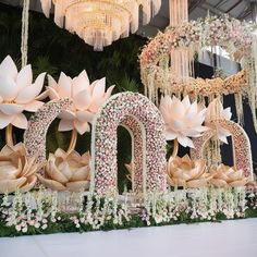 an elaborate floral display with flowers and chandeliers