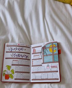 an open book on top of a bed with white sheets and yellow blanket behind it