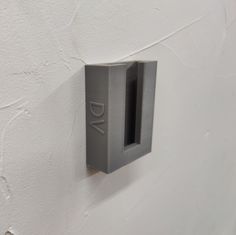 a metal object mounted to the side of a white wall