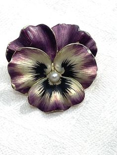 This antique Art Deco 14k gold brooch or pendant is a stunning piece of estate jewelry. The beautiful pansy flower shape is handcrafted and features a single round pearl as the main stone. The brooch is signed  14k. The enamel detailing adds a pop of color to this multicolored gemstone brooch, making it perfect for any occasion, whether it be Mother's Day, Christmas or Valentine's Day. The 14k yellow gold metal and the pinned setting style of this brooch ensure its durability and longevity. This Elegant Flower Enamel Pin Collectible, Brooch Making, Fimo Ideas, Gemstone Brooch, Pansy Flower, Pansies Flowers, Gold Brooch, Gold Brooches, Brooches Handmade