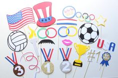 an assortment of sports themed cupcake toppers and cake picks on a white table