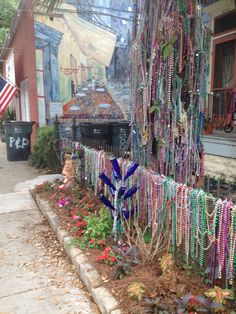 there are many necklaces hanging on the side of this building and it looks like they have been made out of beads