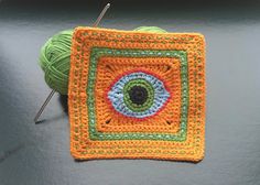 a crocheted square with an eye on it