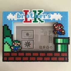 an old nintendo game console with mario and luigi on the cover, in front of a white background