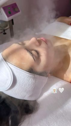 a woman laying down with steam coming out of her eyes and head in the air