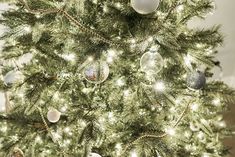 a white christmas tree with ornaments on it