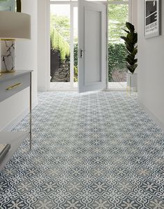 a hallway with blue and white tiles on the floor, two doors leading to another room