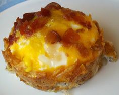 an egg and cheese muffin on a white plate