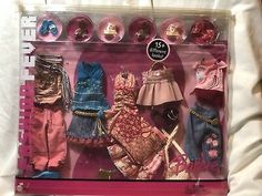 an open package of doll clothes on a bed