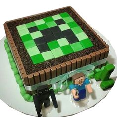 a cake made to look like a minecraft creeper with green and brown decorations