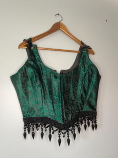 Metallic Green and Black Renaissance Beaded Corset. 1XL Back lace-up and adjustable straps for comfort.  Silk printed fabric with cotton lining and beaded trim.  The black print changes how it looks with lighting and truly adds some sparkle in the sun.  Handmade in Ohio Measurements  Bust 38in-42in waist 32in-36in Luxury Green Corset With Corset Back, Luxury Green Corset, Clothing Lookbook, Pagan Clothing, Beaded Corset, Green Corset, Ren Fair, Future Clothes, Dragon Jewelry