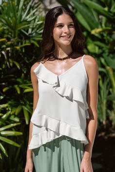 Elevate your wardrobe with the Cream Asymmetrical Ruffle V-Neck Cami. Its modern asymmetrical design and delicate ruffles will add a touch of elegance to any outfit. Product code: CAA04A4B036CC Features:  Woven V-neckline Sleeveless Asymmetrical ruffles Wash Method: Regular Wash Material: 100%POLYESTER. Elegant Asymmetrical Top With Ruffles, Elegant Asymmetrical Ruffled Tops, White Asymmetrical Top With Ruffles, Elegant Tops With Ruffles And Asymmetrical Neckline, Chic Layered Summer Tops, Summer Tops With Ruffles And Asymmetrical Neckline, Make Memories, The Cream, Asymmetrical Design