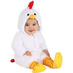 a baby in a chicken costume sitting on the ground