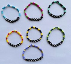 six bracelets with the word love spelled in different colors