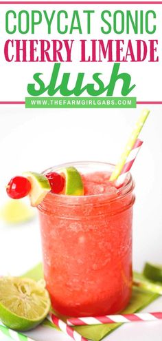 a red drink with limes and cherries in it