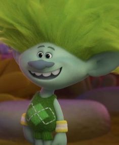 a cartoon character with green hair standing in the middle of a room and smiling at someone