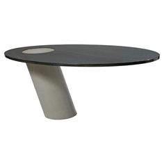 a black and white table sitting on top of a wooden floor