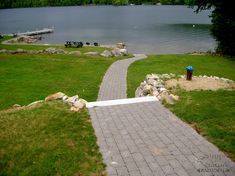 a walkway leading to a lake with boats in the water