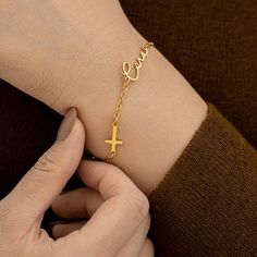 Our Custom Cross Name Bracelet in 18K Gold is a perfect way to add a personal touch to your style. This Necklace is a timeless and iconic addition to any jewelry collection. Whether for yourself or as a meaningful gift for someone special, it's a piece that truly speaks volumes. ◗ Bracelet length: Total Length: 6"+2" (Adjustable Length) ◗ Material: Made of high quality stainless steel with 18K Gold Plated handcrafted necklace ◗Chain Style: Cable Chain ◗Pendant Size: Varies depending on the perso Elegant Personalized Cross Bracelets, Personalized Gold Rosary Bracelet As Gift, Personalized Gold Rosary Bracelet For Baptism, Gold Cross Bracelets For Gifts, Gold Cross Bracelet For Baptism, Elegant Personalized Rosary Bracelet As Gift, Yellow Gold Cross Bracelet For Gift, Yellow Gold Cross Bracelets As Gift, Yellow Gold Cross Bracelet Gift