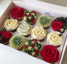 twelve cupcakes in a box decorated with flowers