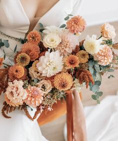 a woman holding a bouquet of flowers in her hands