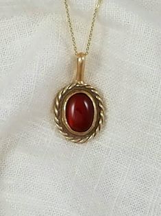 Hand-Crafted Ancient Bronze Pendant with a genuine 10x12 mm Carnelian stone.    Other stone options are available Approx Dimensions:  Length:  1 inch Width: 3/4 inch Total Length with loop: 1 1/4 inches Designed and Handcrafted by Randy from start to finish. Comes with a black adjustable cotton cord. Stones are natural and may vary in color.  Our pieces are made of solid jewelry grade ancient bronze and are not coated with any type of sealant that can chip off.   To keep your piece looking bright and shinny simply use a jewelry polishing cloth. Vintage Oval Cabochon Gemstones, Gold Carnelian Jewelry With Polished Finish, Vintage Carnelian Jewelry With Polished Finish, Formal Carnelian Oval Cabochon Jewelry, Classic Carnelian Yellow Gold Jewelry, Vintage Polished Carnelian Jewelry, Vintage Gemstone Necklace With Oval Cabochon, Classic Jewelry With Large Oval Cabochon Stone, Classic Yellow Gold Carnelian Jewelry