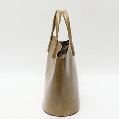 Discover Everyday Elegance Step into the world of sophistication with our Elegant Vegan Leather Tote Bag, a perfect blend of style and functionality. Crafted for the modern woman, this bag is not just an accessory; it's a statement. Whether you're heading to work, a casual outing, or a special event, this tote bag will elevate your style with its simple yet chic design. Product Features Our tote bag stands out with its unique bucket shape, offering a fresh take on the classic tote design. The bl Tote Design, Vegan Leather Tote Bag, Vegan Leather Tote, Everyday Elegance, Bag Stand, Ethical Fashion, Shopping Trip, Design Product, Leather Tote Bag