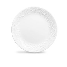 a white plate with an ornate design on the front and side, against a white background