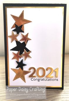 a card with gold and black stars on it