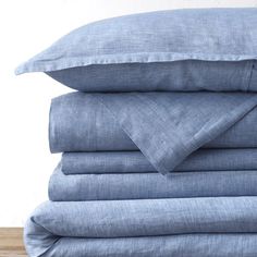 blue linen sheets stacked on top of each other