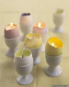 there are many different colored candles in egg shells