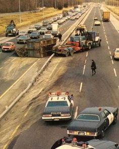 police cars and trucks are on the road