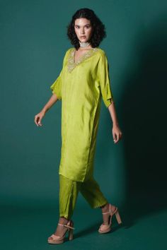 Green handwoven mulberry silk kaftan kurta adorned with zardozi embroidery. Comes with tissue Afghan pant.
Components: 2
Pattern: Embroidered
Type Of Work: Zardozi
Neckline: V Neck
Sleeve Type: Batwing Sleeves
Fabric: Silk, Tissue
Color: Green
Other Details: 
Lace trims on sleeves
Occasion: Puja - Aza Fashions Festive Silk Kaftan With Gota Work, Silk Kurta With Resham Embroidery Tunic, Silk Kaftan With Gota Work In Traditional Drape, Silk Tunic Kurta With Resham Embroidery, Silk Resham Embroidery Kurta Tunic, Silk Resham Embroidery Tunic Kurta, Straight Kurta Kaftan In Silk With Dabka Work, Designer Silk Kaftan With Gota Work, Silk Straight Kurta Tunic For Eid