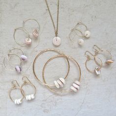 Puka Shell Hoop Earrings~ Beautiful Hawaiian puka shells adorn small tube hoops. Great gift for the beach lover! Hoops 2 X 18mm. Choose 14k gold fill, rose gold fill or sterling silver from the drop down menu. Models wearing similar designs. Shop~ http://www.etsy.com/shop/HanaMauiCreations?ref=pr_shop_more International buyers please read our shipping policies before ordering~ POLICIES~ https://www.etsy.com/shop/HanaMauiCreations/policy?ref=shopinfo_policies_leftnav Surfer Girl Gifts, Shell Hoop Earrings, Rose Gold Hoop Earrings, Puka Shell Necklace, Tahitian Pearl Necklace, Crystal Point Necklace, Black Pearl Necklace, Small Gold Hoops, Hawaiian Jewelry