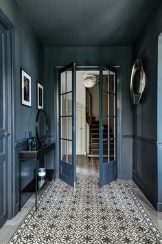 a hallway with blue walls and black doors