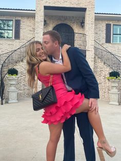 a man in a suit and tie hugging a woman