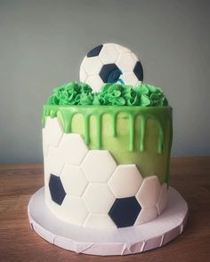 a soccer themed cake with green icing and sprinkles on the top