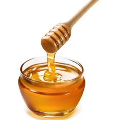 a honey dip in a glass bowl with a wooden stick sticking out of the top