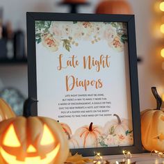 a framed sign that says, eat night diapers next to pumpkins and candles