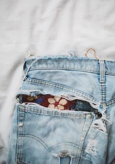 an old pair of jeans with holes in the back pocket that have been ripped open