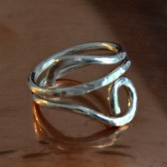 This ring was hand formed and textured from 12 gauge solid sterling wire. Would look great on any finger including your thumb. It weighs .20 ounces. each ring is made when ordered so please allow for minor differences and it will be truly one of a kind Comes gift boxed 100% satisfaction guaranteed Ships USPS insured first class mail and with tracking to most locations Please read my policies carefully prior to purchase want to see more rings? http://www.etsy.com/shop/Untwistedsister?section_id=1 Hand Forged Sterling Silver Rings With Open Band, Silver Hammered Open Band Rings, Unique Hand Forged Open Band Jewelry, Unique Hand Forged Toe Ring, Unique Hammered Stackable Rings For Promise, Hand Forged Adjustable Midi Rings As Gifts, Adjustable Hand Forged Midi Rings As Gift, Adjustable Hand Forged Sterling Silver Rings, Unique Adjustable Sterling Silver Ring