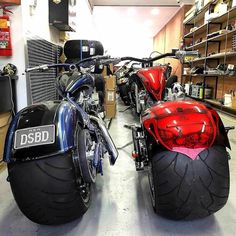 two motorcycles parked next to each other in a garage