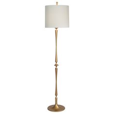 a gold floor lamp with a white shade