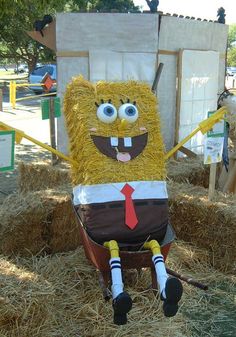 an inflatable character sitting on top of hay