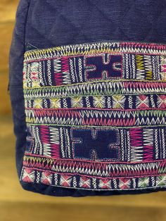 "Hand embroidered navy blue backpack featuring traditional Akha Hill Tribe patterns & motifs hand-sewn by artisans in Northern Thailand. A quilted 100% cotton backpack with a front zipper pocket, 14\"x 12\" inch main compartment, and adjustable straps with 5\" inch wide flat base . The Akha's colorful diamond and triangle appliqué combined with cross stitch embroidery are unique to this Hill Tribe, whose women are known for their elaborate headdresses decorated with beads, seeds, and coins. Traditional Travel Backpack, Navy Blue Backpack, Cotton Backpack, Perfect Travel Bag, Applique Pillows, Northern Thailand, Hill Tribe Silver, Blue Backpack, A Perfect Day