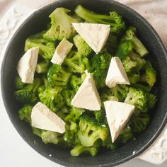 broccoli and cheese in a skillet on a table